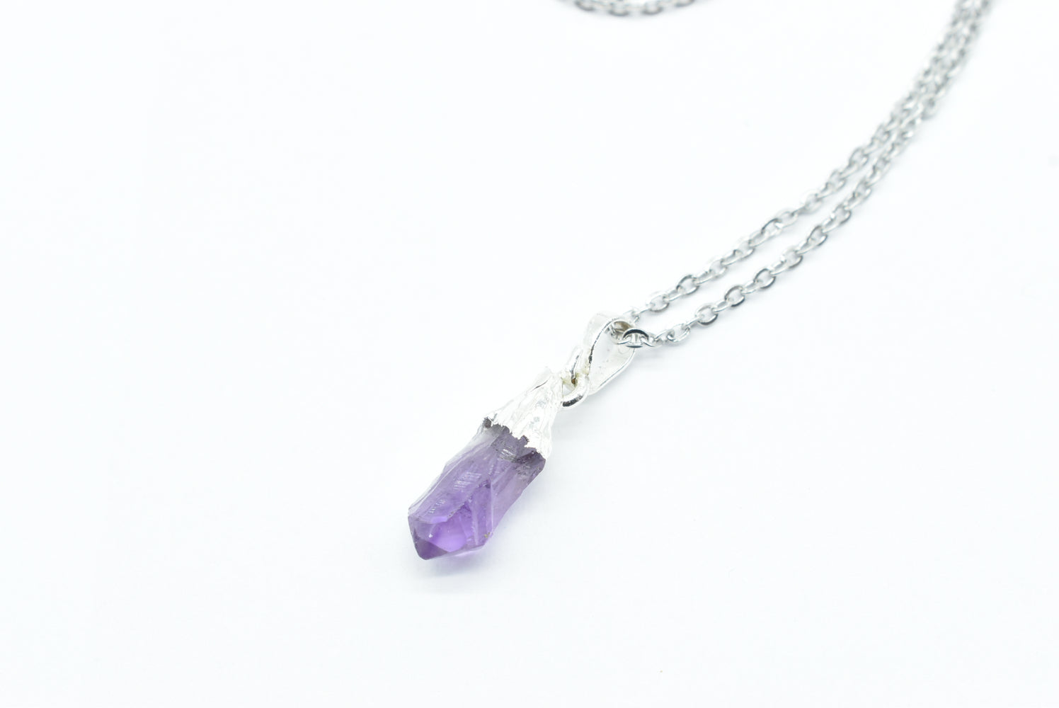 Raw Amethyst Pendant with brass-colored contours