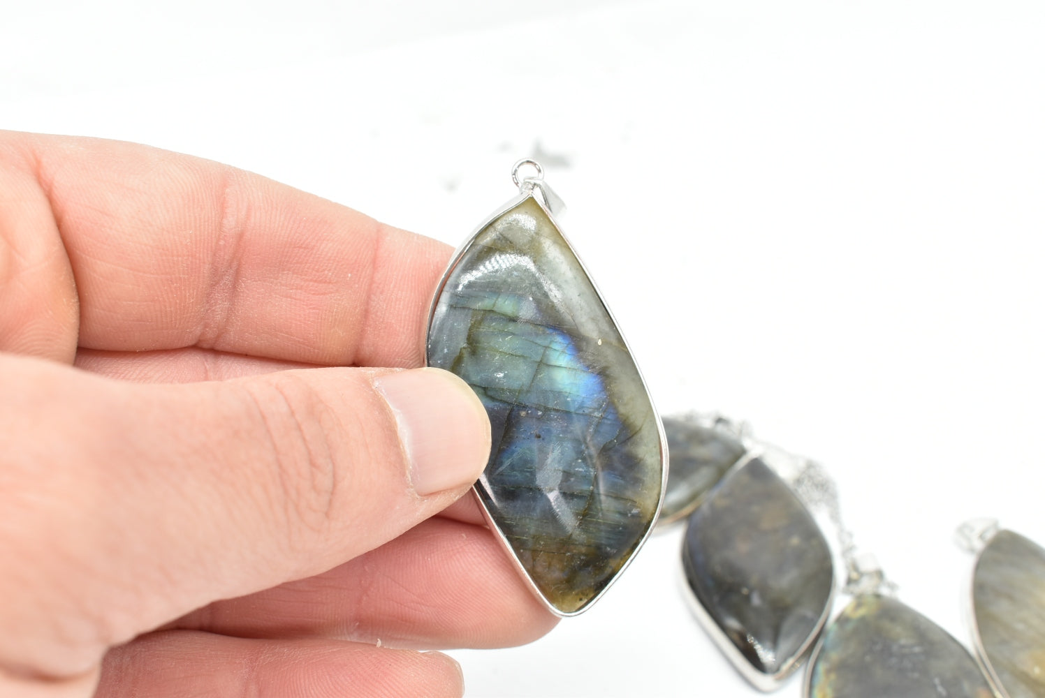 Labradorite leaf pendant with silver colored supports