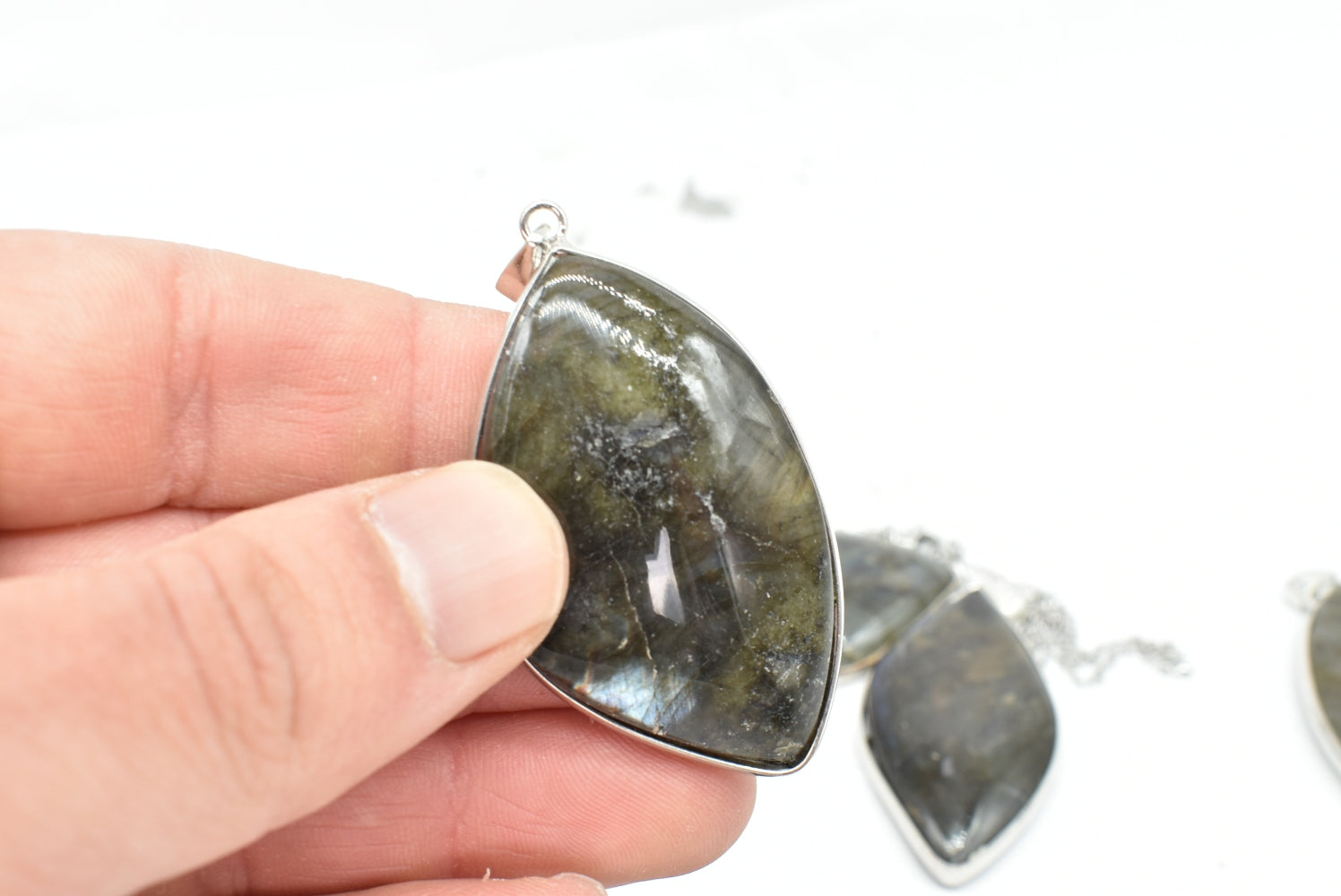 Labradorite leaf pendant with silver colored supports