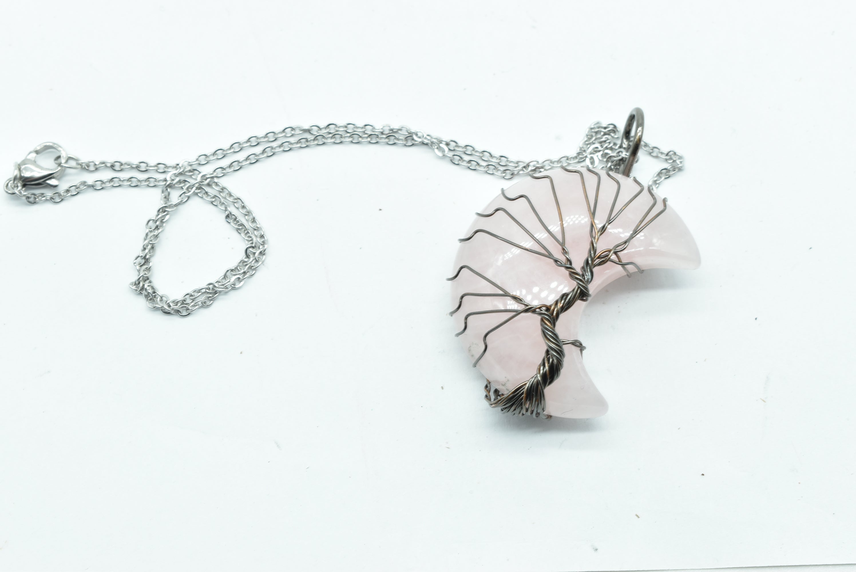 Rose Quartz Moon Pendant wrapped in silver colored wire